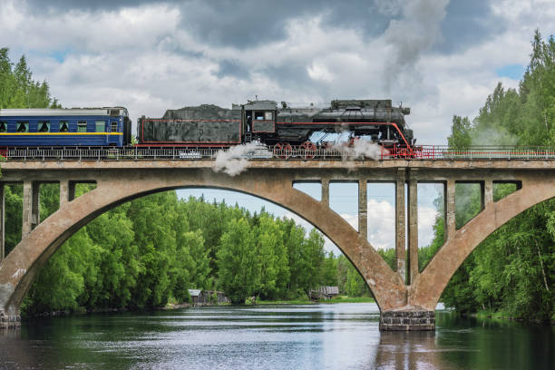 istock Retro steam train moves above the river. 2165599131