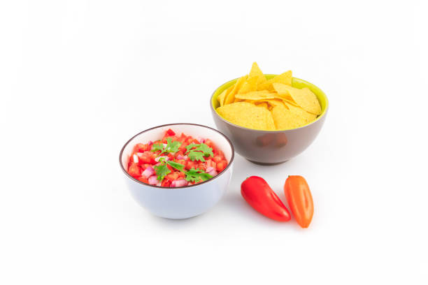 Nachos and salsa pico de gallo in a bowl isolated on white background. DSRL Studio photo taken with Canon EOS 5D Mark II and EF100mm f/2.8L Macro IS USM Lens