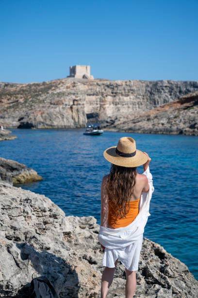 istock Woman explores cliff above sea 2165601689