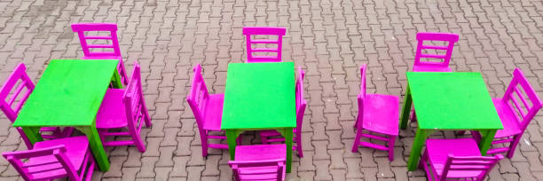 Vibrant green tables and pink chairs, top view