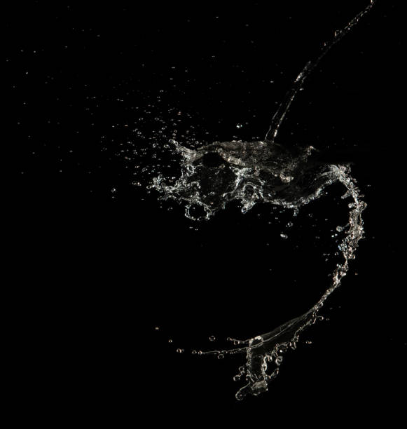 istock Crown water to object make curve drop explosion in ripple motion. Black background isolated. Crown Water splash on object to create shape form fluttering in droplet and wave. 2165609140