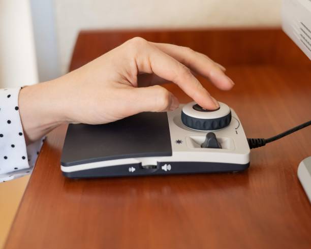 istock A woman uses a special magnification device for the visually impaired. 2165610106