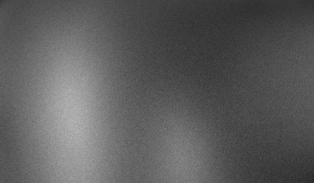 Gradient blurry matte grey backdrop with noise abstract sanded metallic monochrome background