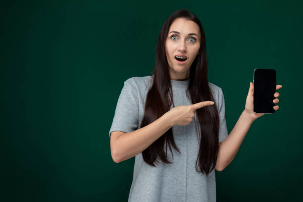 istock Woman Holding Cell Phone in Hand 2165612454