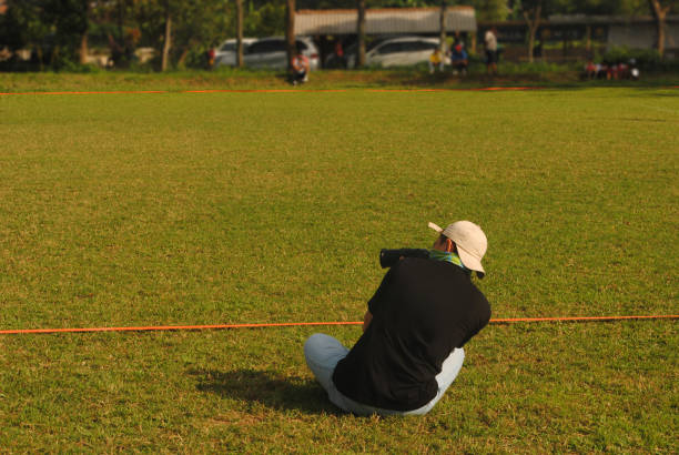 istock Photographer taking shoot on the field. 2165617963