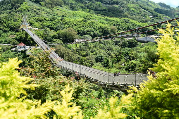 A long suspended wooden bridge in the forest park YaNoDa, A national park in the center of Hainan Island, China.