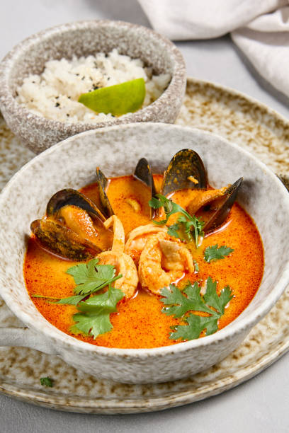 istock Thai Tom Yum Seafood Soup with Rice on Stoneware Plate 2165624482