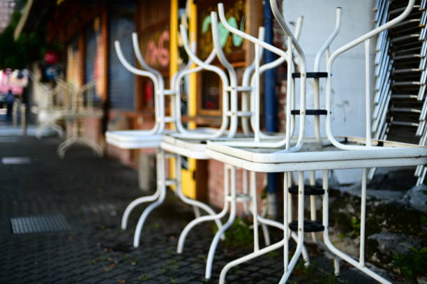 Morning Street Scene: Neatly Stacked Steel Garden Tables