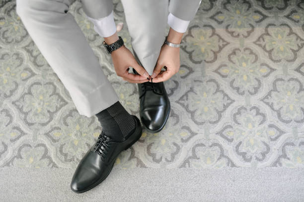 istock The groom ties his shoelaces 2165626117