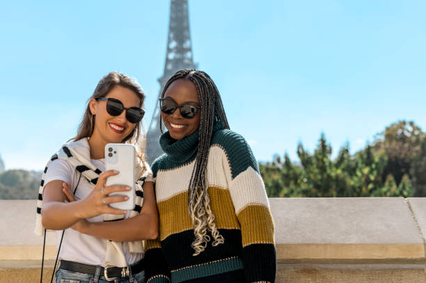 istock Multiethnic girlfriends taking selfie with cellphone, sightseeing together in Paris 2165626821