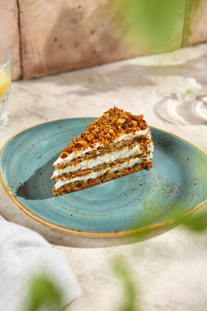 istock Authentic Carrot Cake Slice on Blue Plate Textured Still Life in Natural Sunlight 2165627932