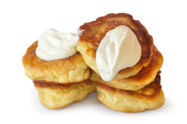 istock Thick homemade pancakes with sour cream on a white background. 2165630640