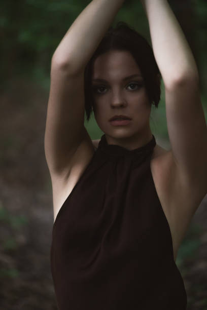 istock Mysterious Woman in Forest Setting 2165632260