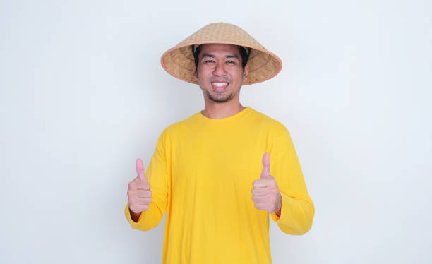 istock Asian farmer smiling and give two thumbs up 2165634788