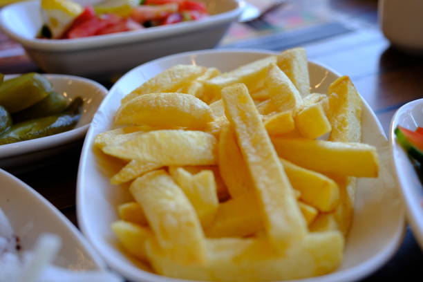 Close-up shot of thinly sliced ​​tomatoes, roasted peppers and potatoes in pan. Turkish salad varieties. Turkish cuisine.