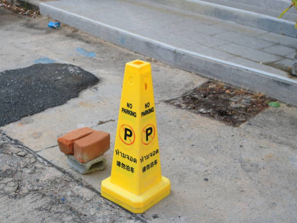 istock Yellow plastic traffic cone on street and black letter. 2165638937