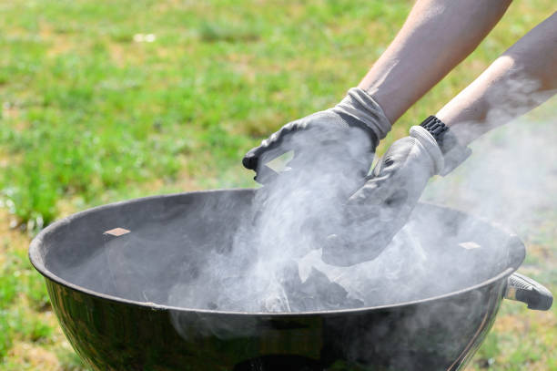istock Man lighting a garden grill with charcoal 2165643727