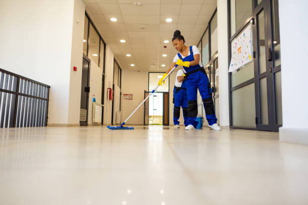 istock Two Janitors in uniform cleaning the  floor in school hallway 2165643828