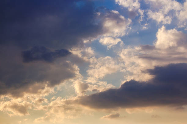 istock dramatic dusk. dynamic clouds on the sky in golden light above the horizon 2165645504
