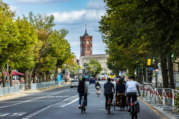 Cyclists in Berlin, red town hall in the background