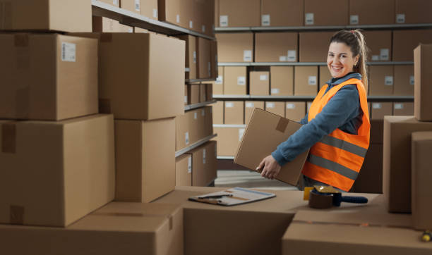 istock Portrait of a warehouse worker carrying a box 2165649271