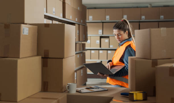 istock Woman working with a laptop at the warehouse 2165649344