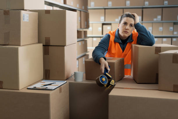 istock Tired depressed woman working in a warehouse 2165649419