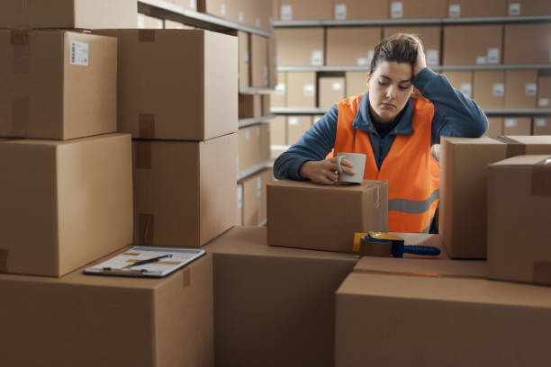 istock Tired warehouse employee having a break 2165649437