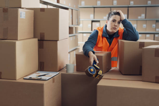 istock Tired depressed woman working in a warehouse 2165649521