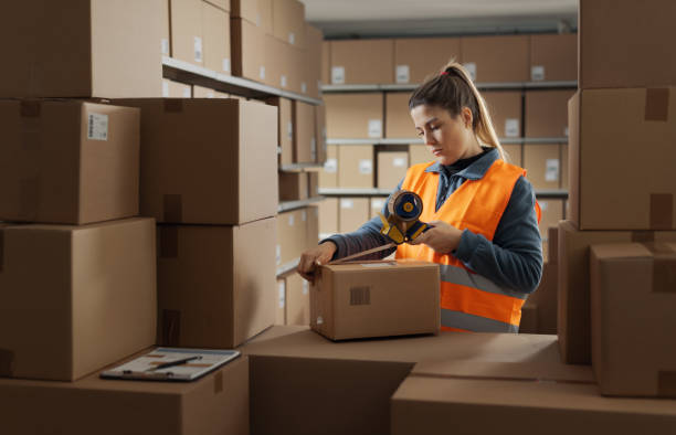 istock Warehouse employee sealing a delivery box 2165649655