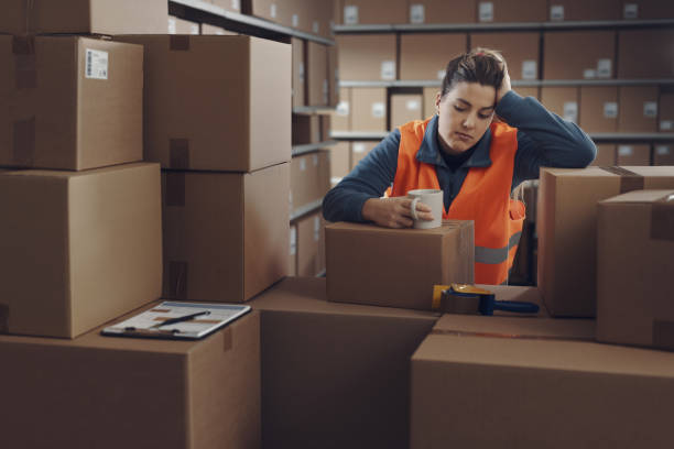 istock Tired warehouse employee having a break 2165649770
