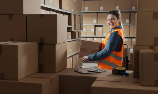 istock Portrait of a warehouse worker carrying a box 2165650664