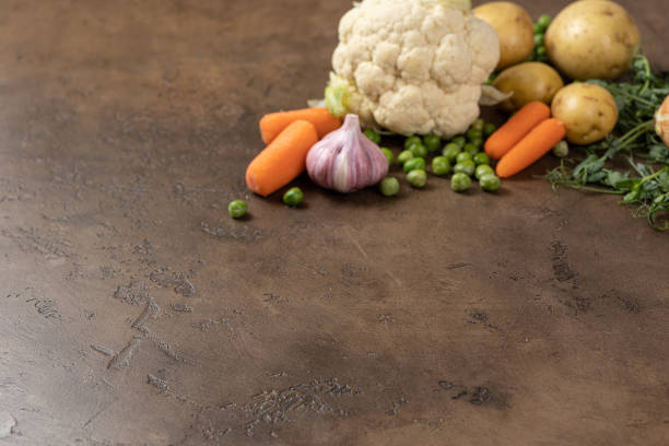 A vibrant assortment of fresh vegetables like carrots, cauliflower, and nutritious potatoes on a rustic surface