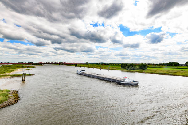 Ship carrying bulk goods over the river IJssel summer day in the IJsseldelta region near Zwolle in Overijssel, The Netherlands.