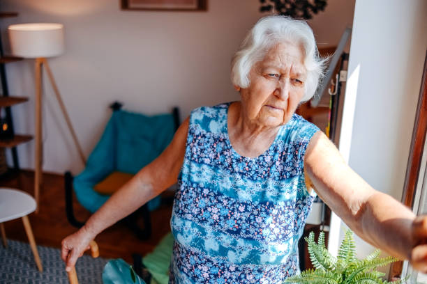 istock Old people spending time alone at home in living room feeling sadness while looking through window 2165654263