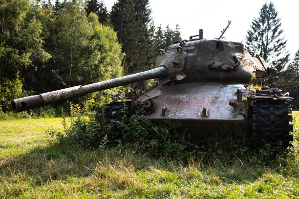 Qana, Lebanon - September 2, 2010: A young Lebanese woman sits atop an abandoned tank in southern Lebanon, looking at a landscape that has known much war.