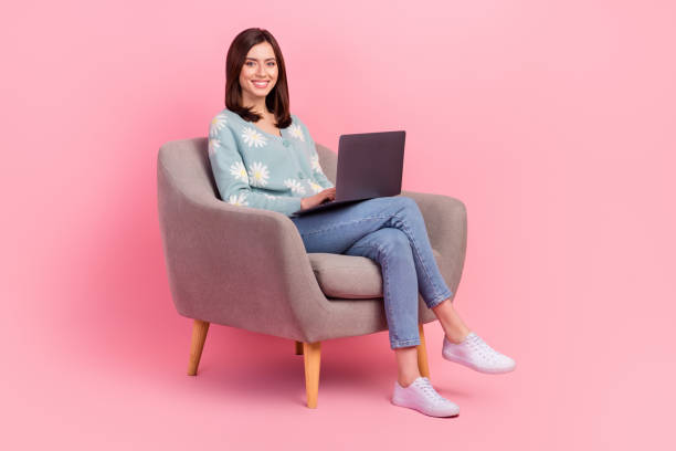 istock Full body size photo of young future it specialist woman sitting chair learning code python language isolated on pink color background 2165654423