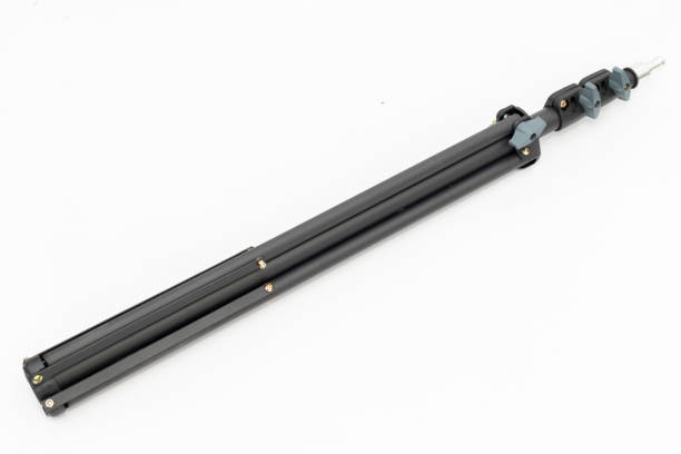istock Black tripod light stand folded on white isolated background. 2165656045