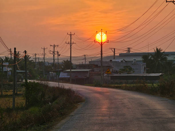 Dawn on the asphalt road with electric poles