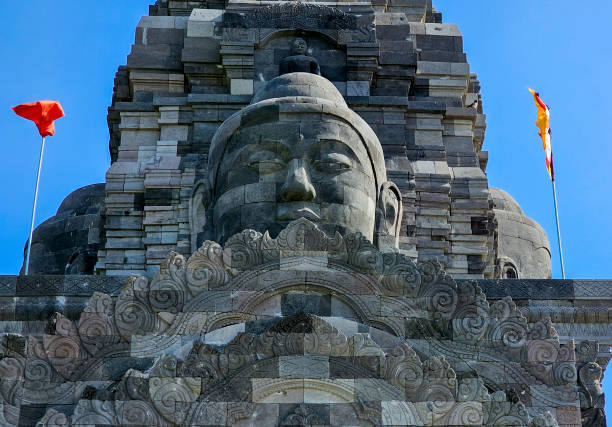 istock Buddha statue carved on the temple gate 2165658879