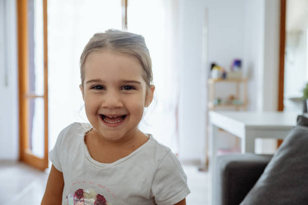 istock Cute little girl looking at camera and smiling 2165661318
