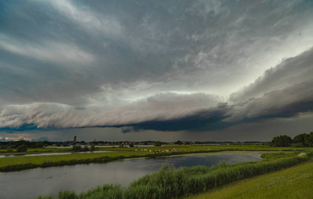 Dramatic shelf cloud or arcus over a river Waal in the central part of The Netherlands.