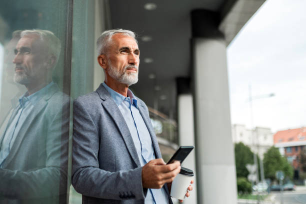 istock Businessman on Coffee Break with Smartphone 2165662140