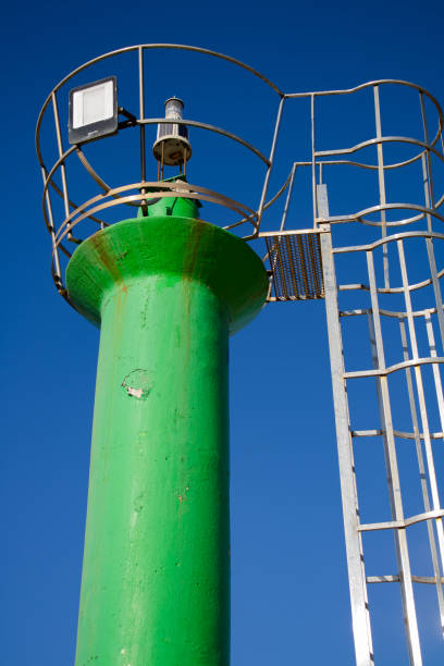 istock Image of a green lighthouse and behind it the beautiful blue sky 2165665542