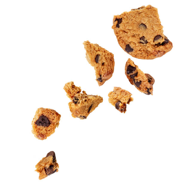 istock Explotion of Broken chocolate chip cookies   isolated on white background.. Cookies broken in pieces with crumbs. 2165665651
