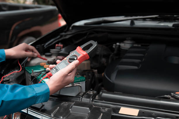 istock Mechanic uses multimeter to check car battery 2165665847