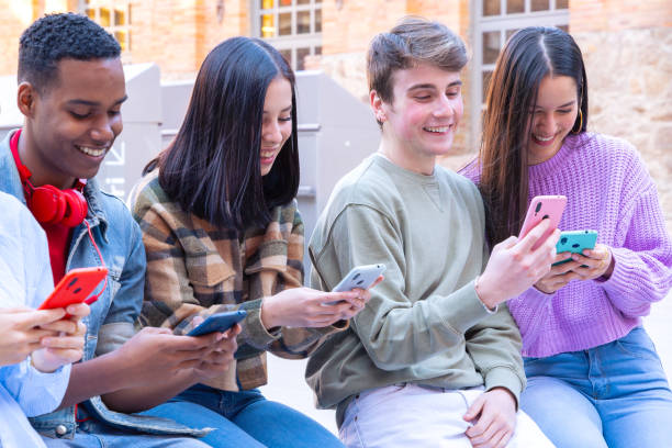 istock Students having fun with mobile phones creating content on social media. 2165665967