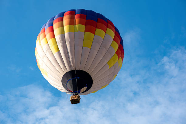 istock A colorful hot air balloon floating across the blue sky 2165666708