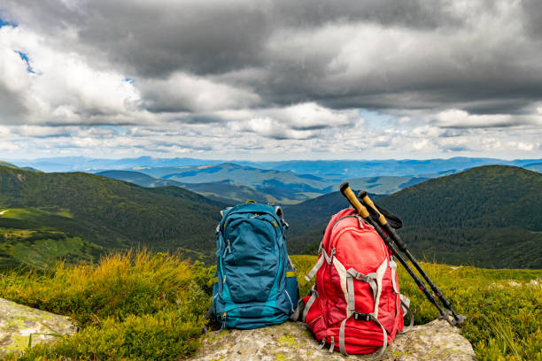 Mountain landscape with peaks and backpacking equipment.