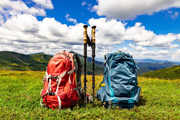 Hiking in the mountains with two backpacks in the summer.